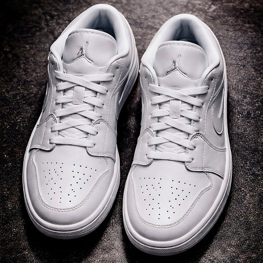 Air Jordan 1 Low Triple white top view on polished dark concrete floor
