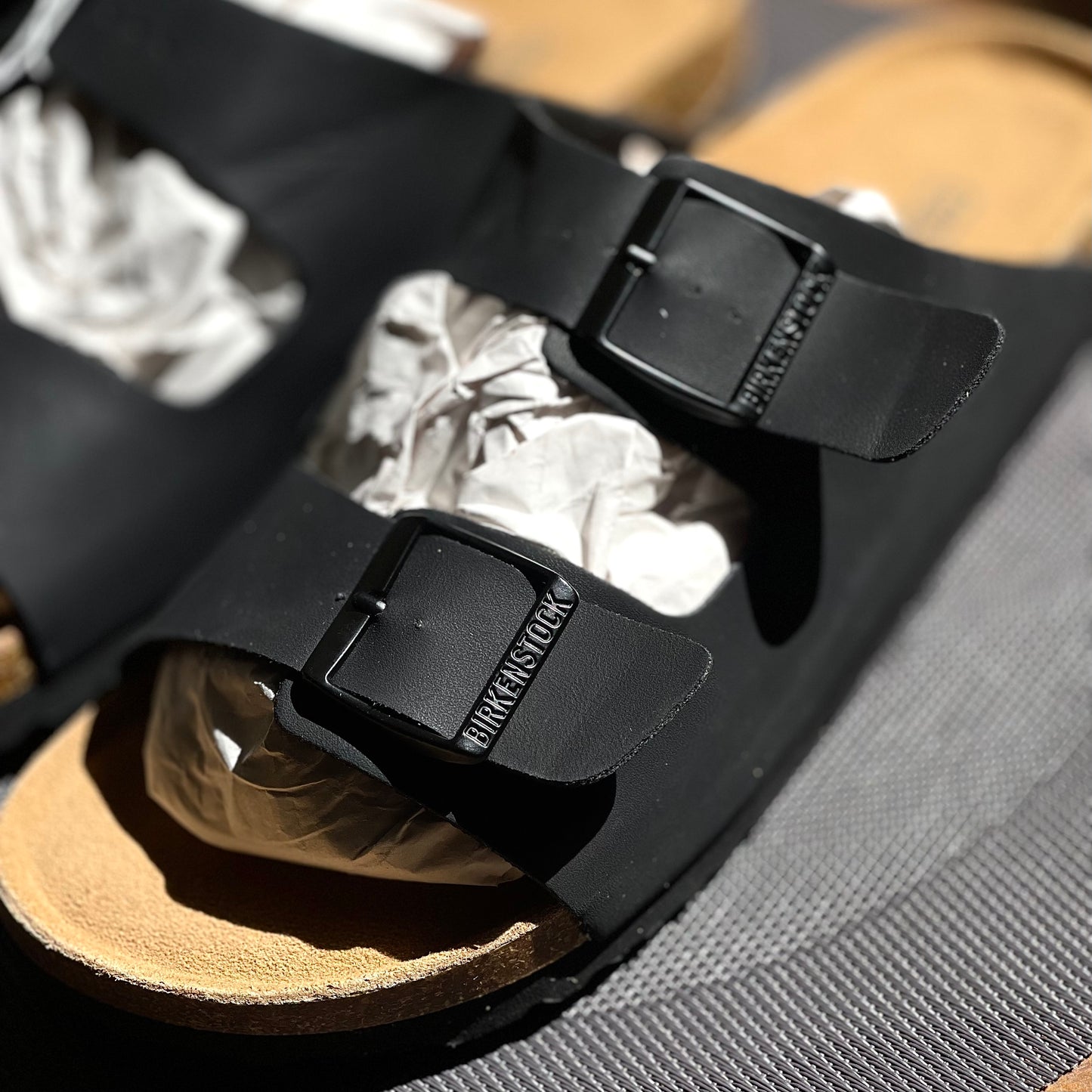 Close-up of Birkenstock Arizona Birko-Flor Black straps with metal buckles