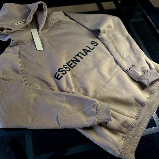 Angled view of Fear of God Essentials Hoodie Light Oatmeal — cozy neutral-toned hoodie highlighting relaxed streetwear design