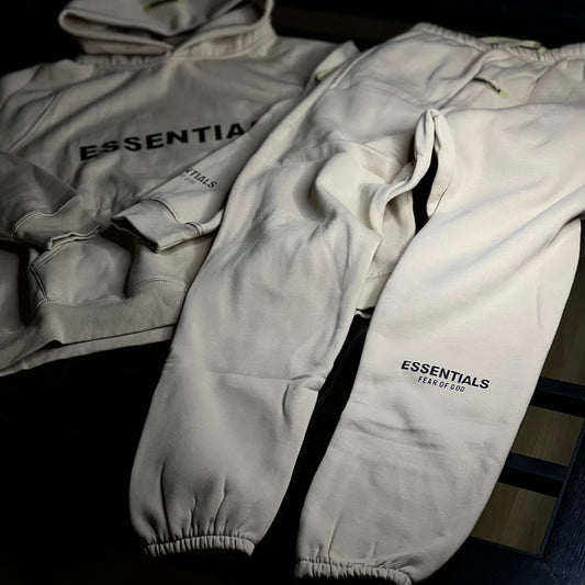 Fear of God Essentials 2-Piece Tracksuit Dusty Beige front view — hoodie and matching joggers in neutral beige with relaxed fit