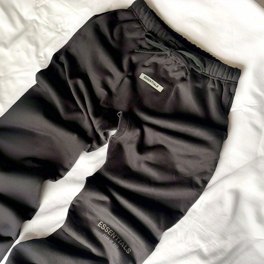 Side profile of Fear of God black core sweatpants