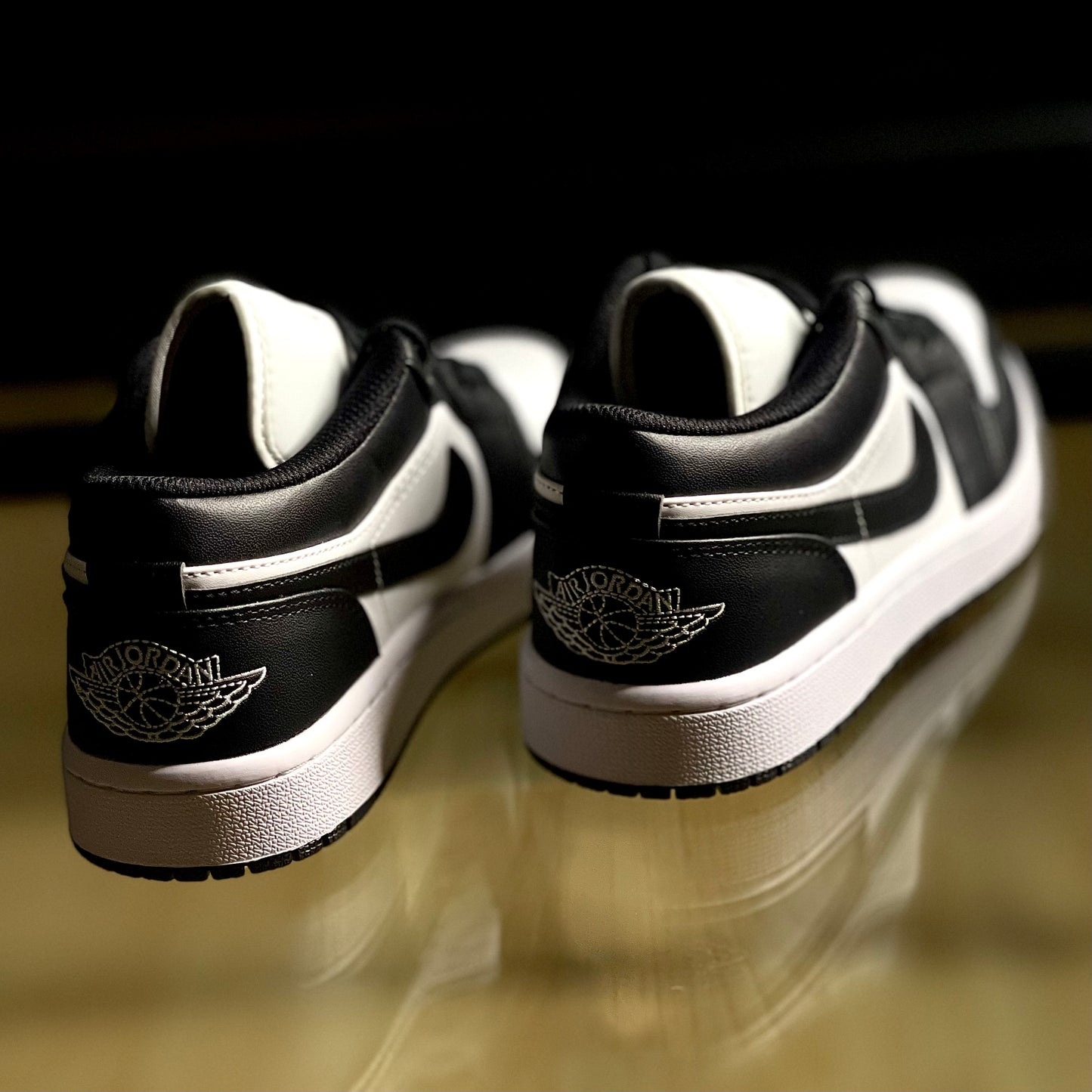Rear angle of Air Jordan 1 Low Panda highlighting Jumpman logo and contrast detailing