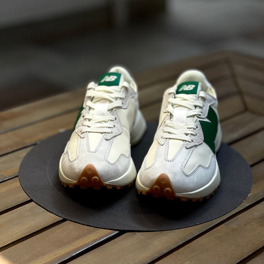 Pair of New Balance 327 white and green sneakers on a wooden surface_2