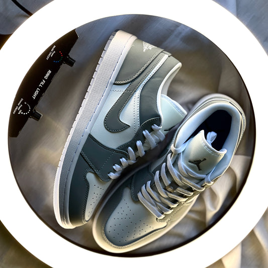 Air Jordan 1 Low Wolf Grey side profile highlighting smooth leather panels, Swoosh logo, and clean neutral colourway.