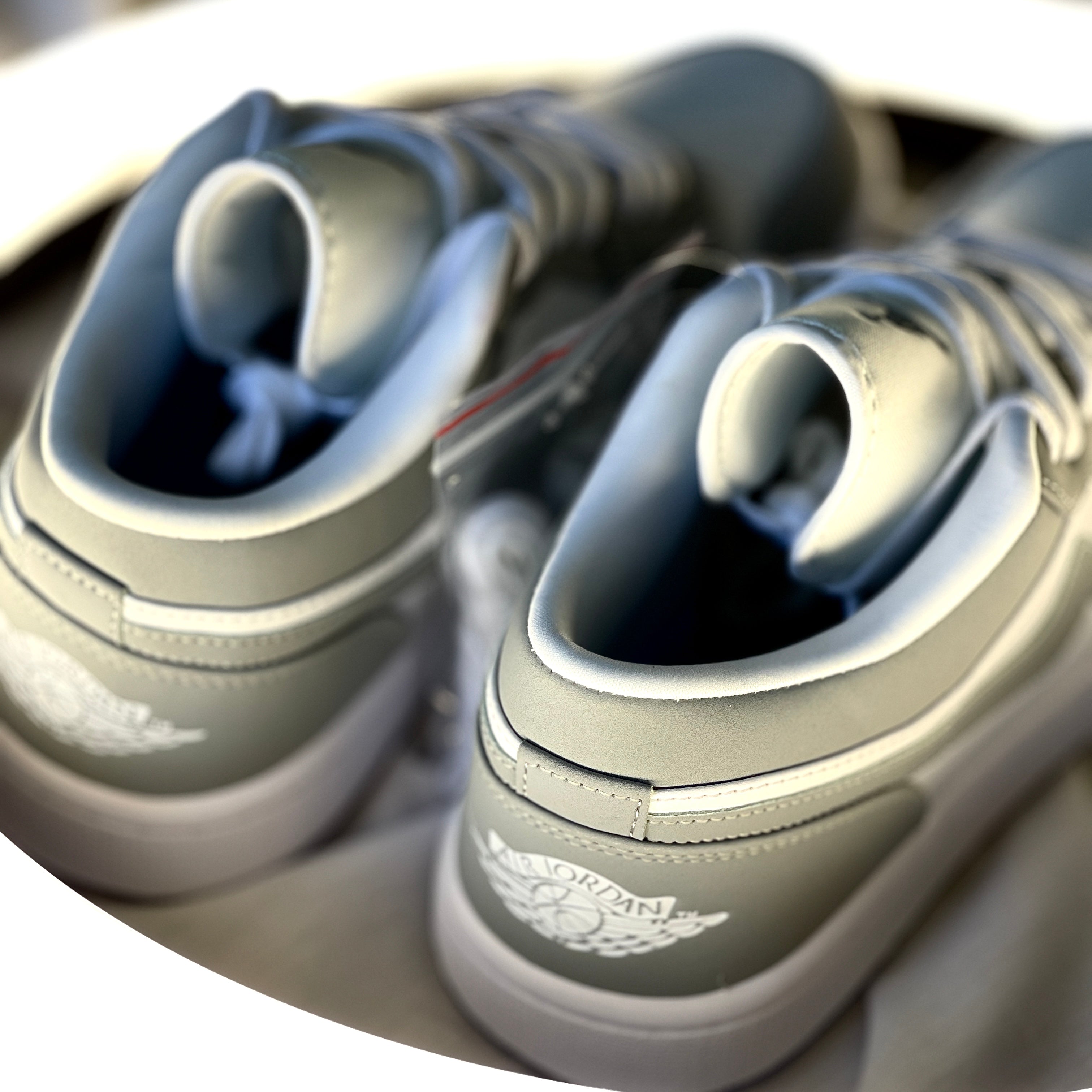Air Jordan 1 Low Wolf Grey rear view with embroidered Air Jordan Wings logo and grey heel panel.