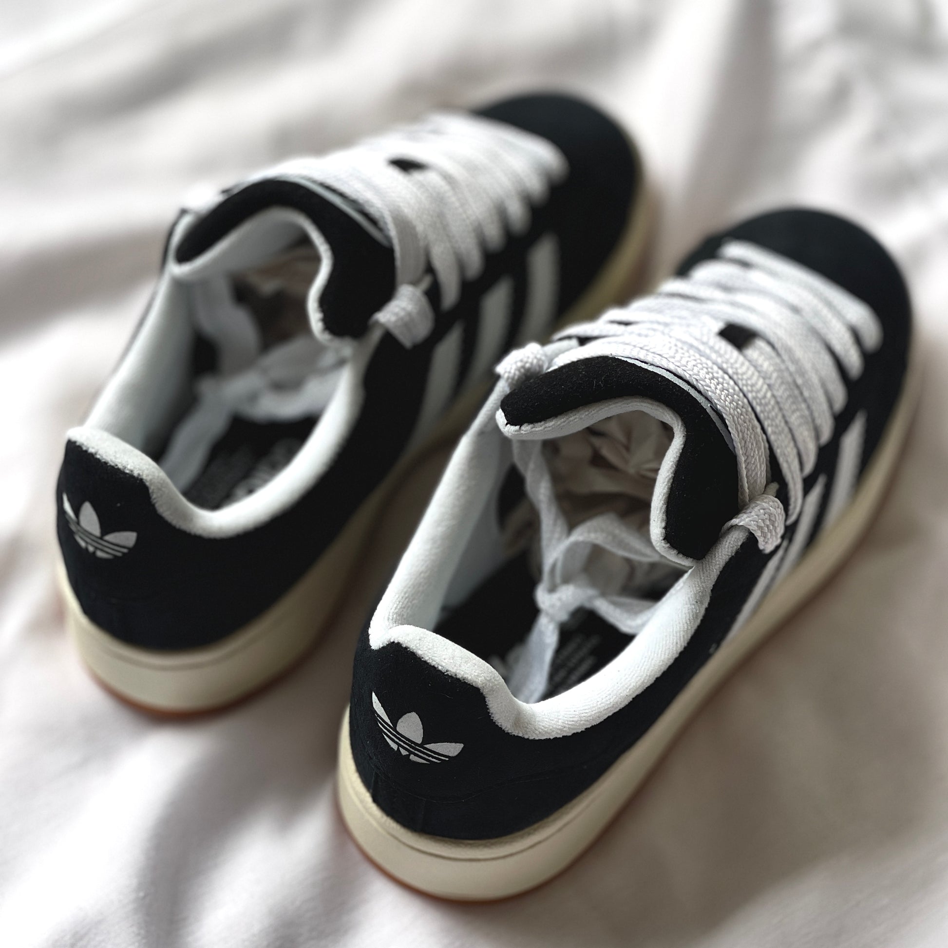 Heel tab and branding on adidas Campus black sneaker