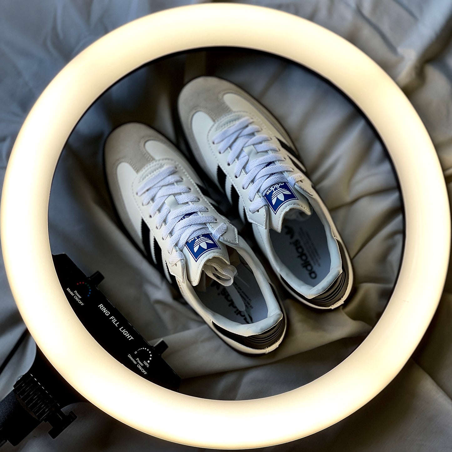 Adidas Samba OG showing black three-stripe design and gold Samba branding detail