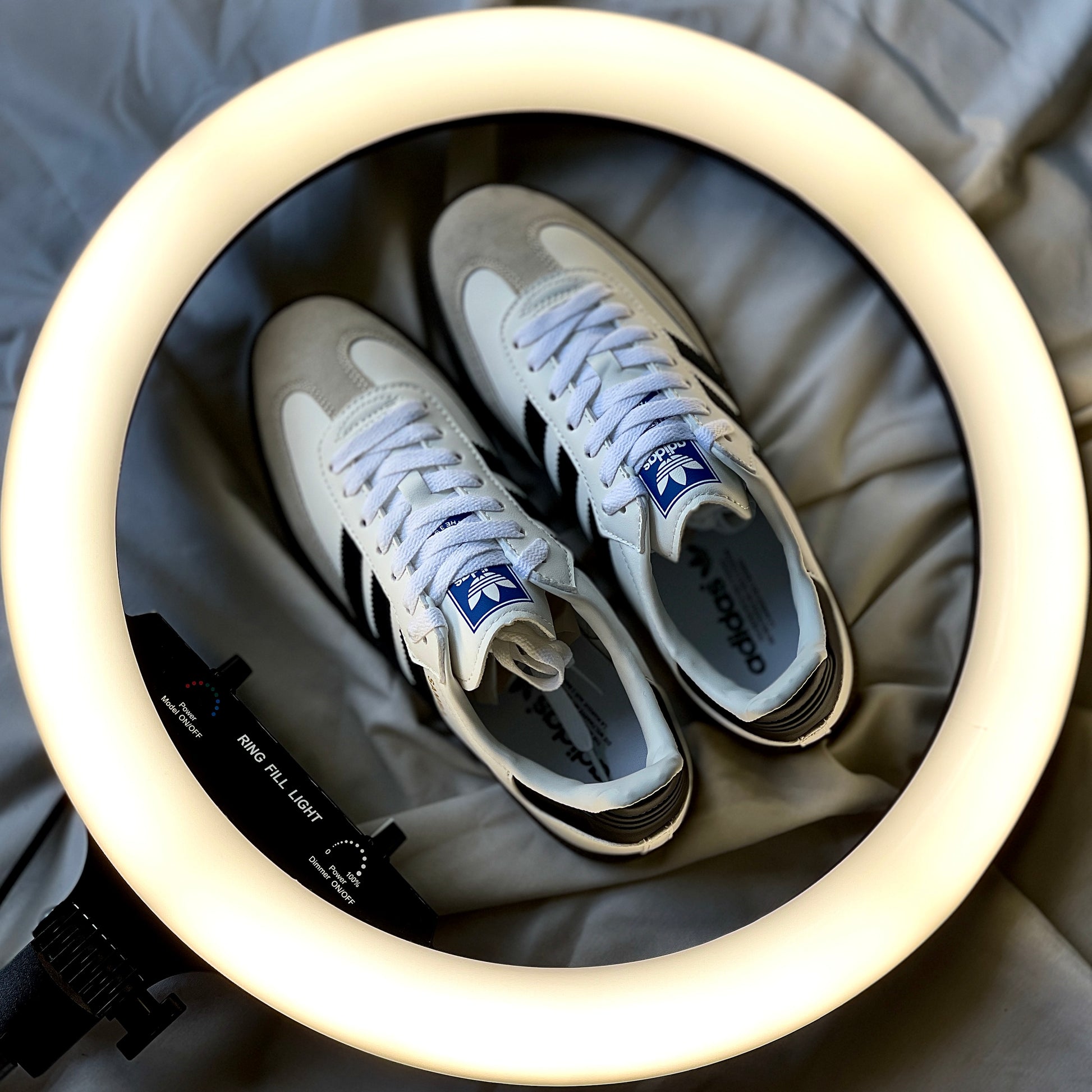 Adidas Samba OG showing black three-stripe design and gold Samba branding detail