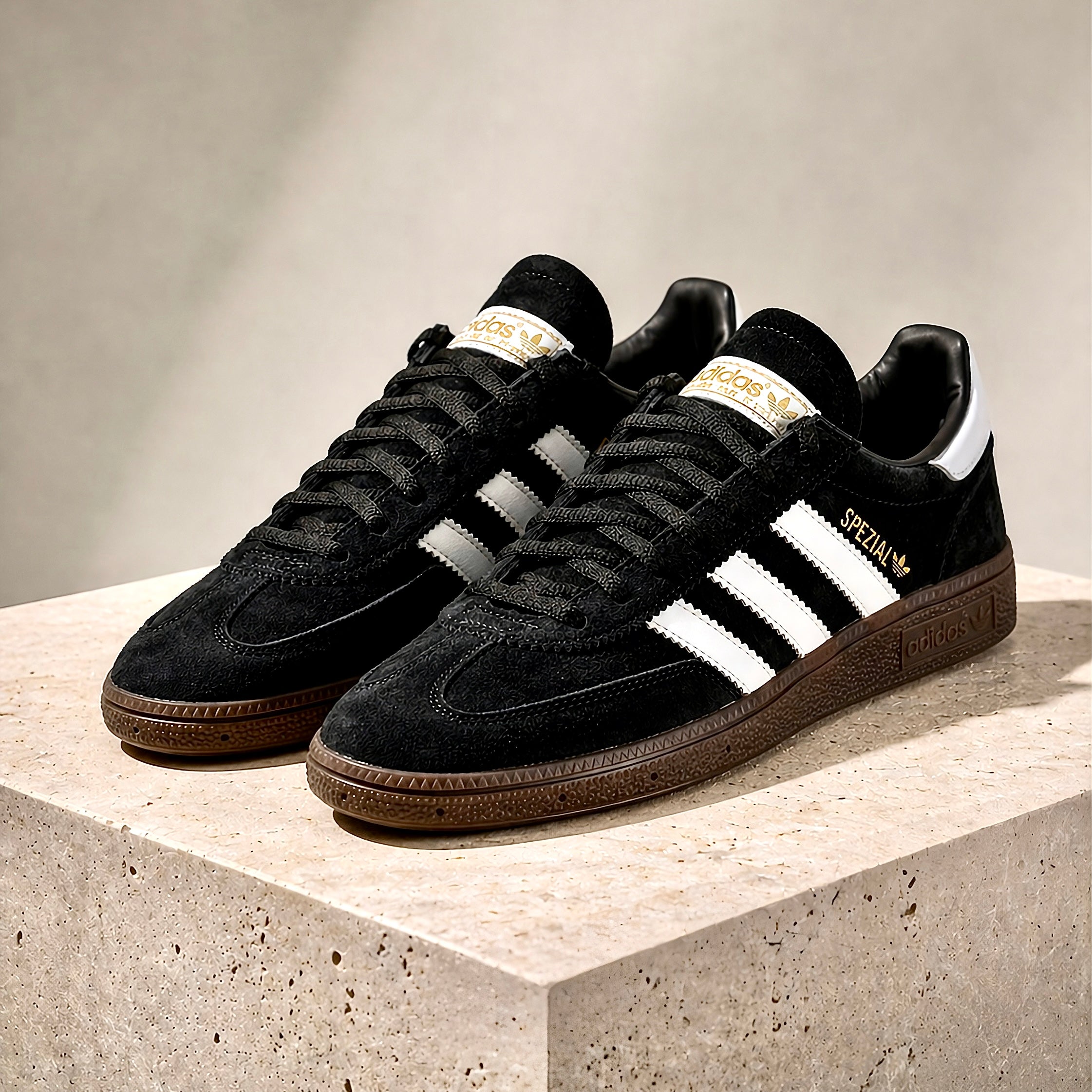 Pair of adidas Handball Spezial Black Gum sneakers angled together