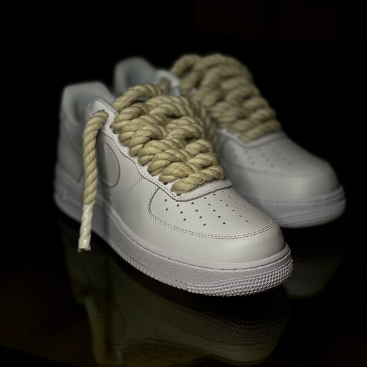 Close-up of Nike Air Force 1 Low Triple White leather upper with rope laces and perforated toe box