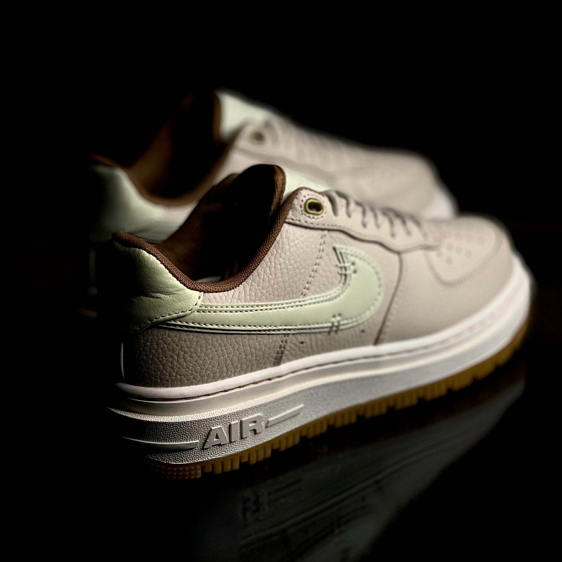 Angled view of Air Force 1 Luxe Pecan — luxury brown leather sneaker with gum sole and detailed stitching