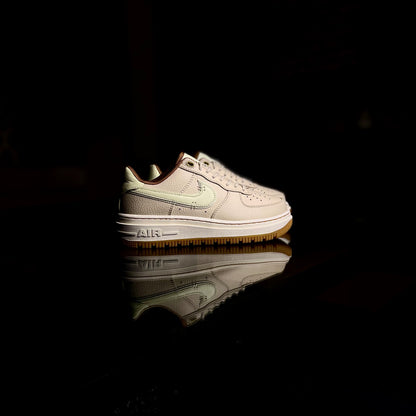 Nike Air Force 1 Luxe Pecan side view — brown leather sneaker with gum sole and stitched detailing