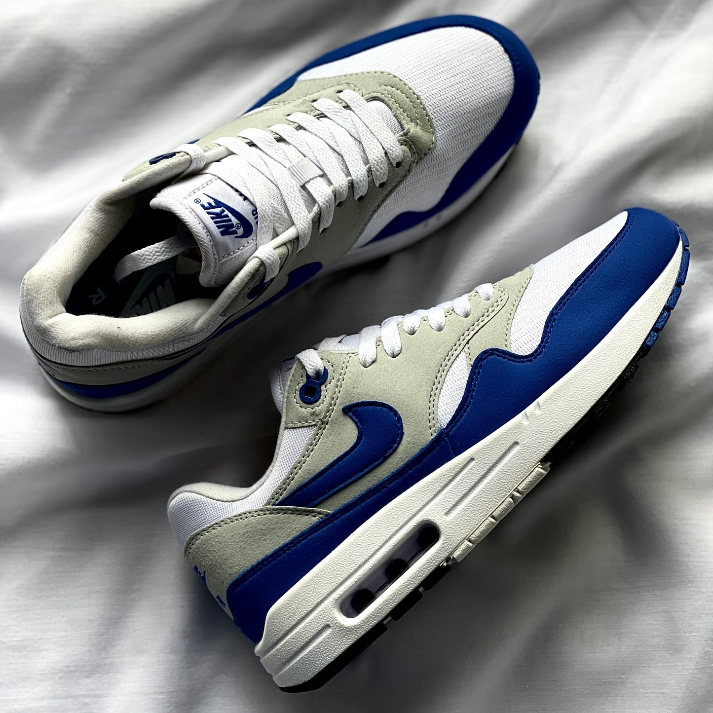 Pair of Nike Air Max 1 OG Royal sneakers angled together
