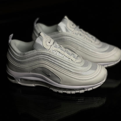 Nike Air Max 97 Triple White side view — all-white sneaker with signature wavy upper lines and full-length visible Air unit
