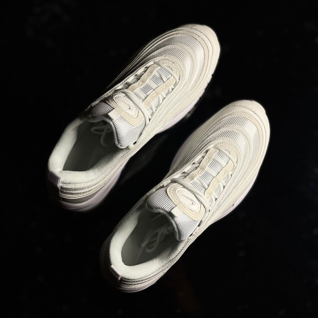 Top view of Air Max 97 Triple White — white mesh and synthetic upper with tonal laces and sleek silhouette
