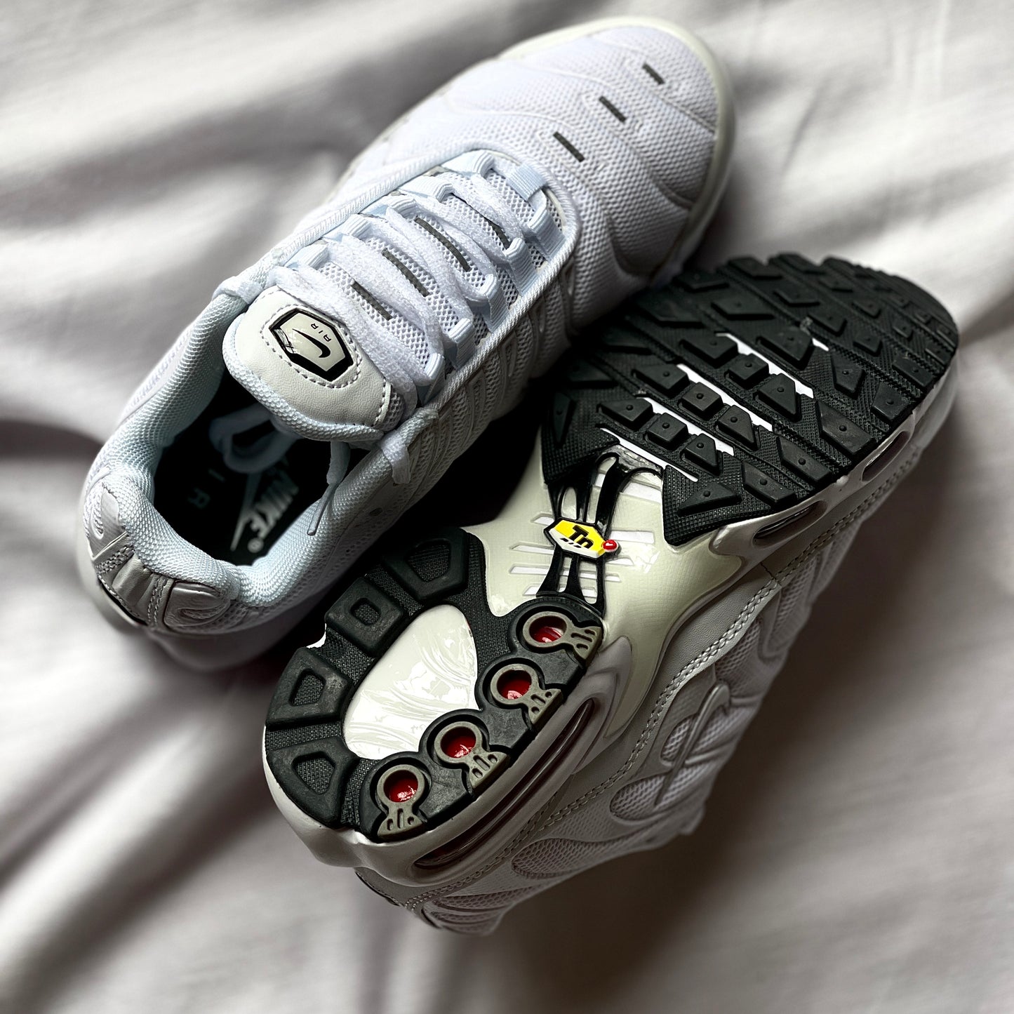 Outsole of Nike Air Max Plus Triple White featuring durable rubber with traction pattern.