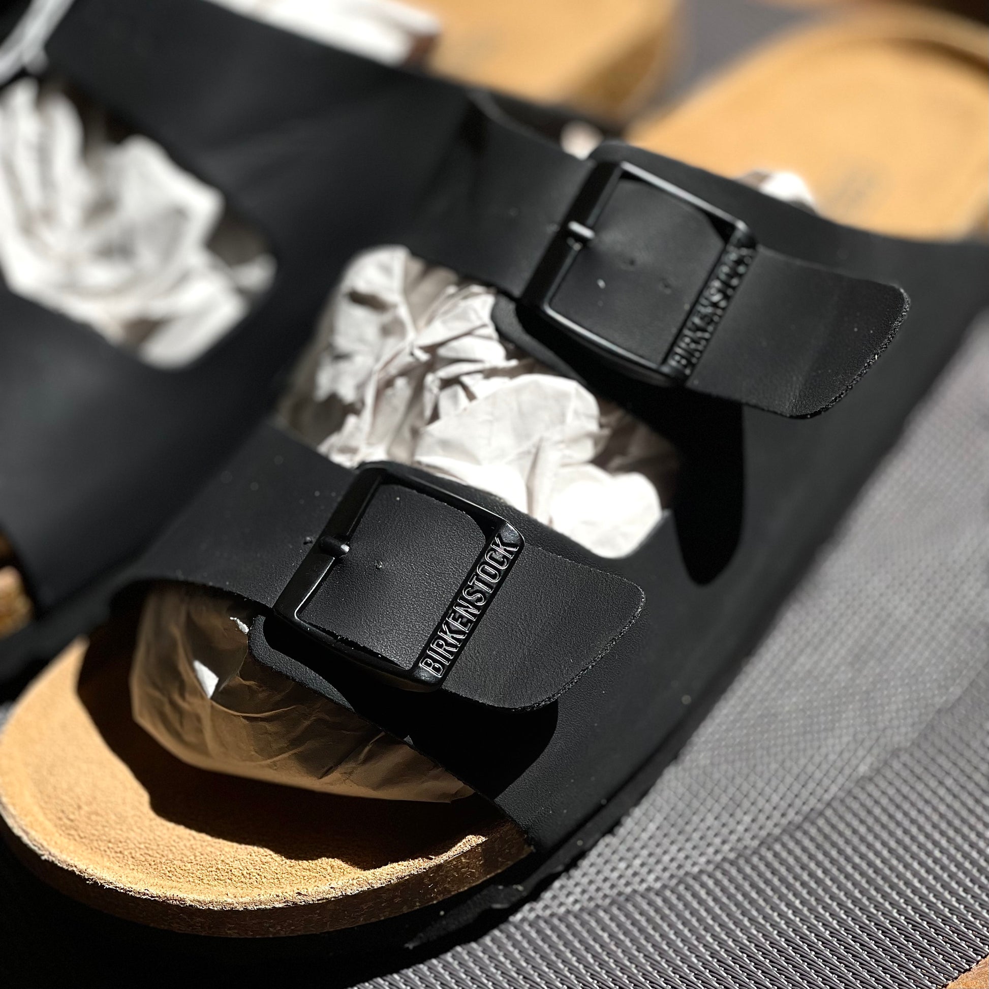 Close-up of Birkenstock Arizona Birko-Flor Black straps with metal buckles