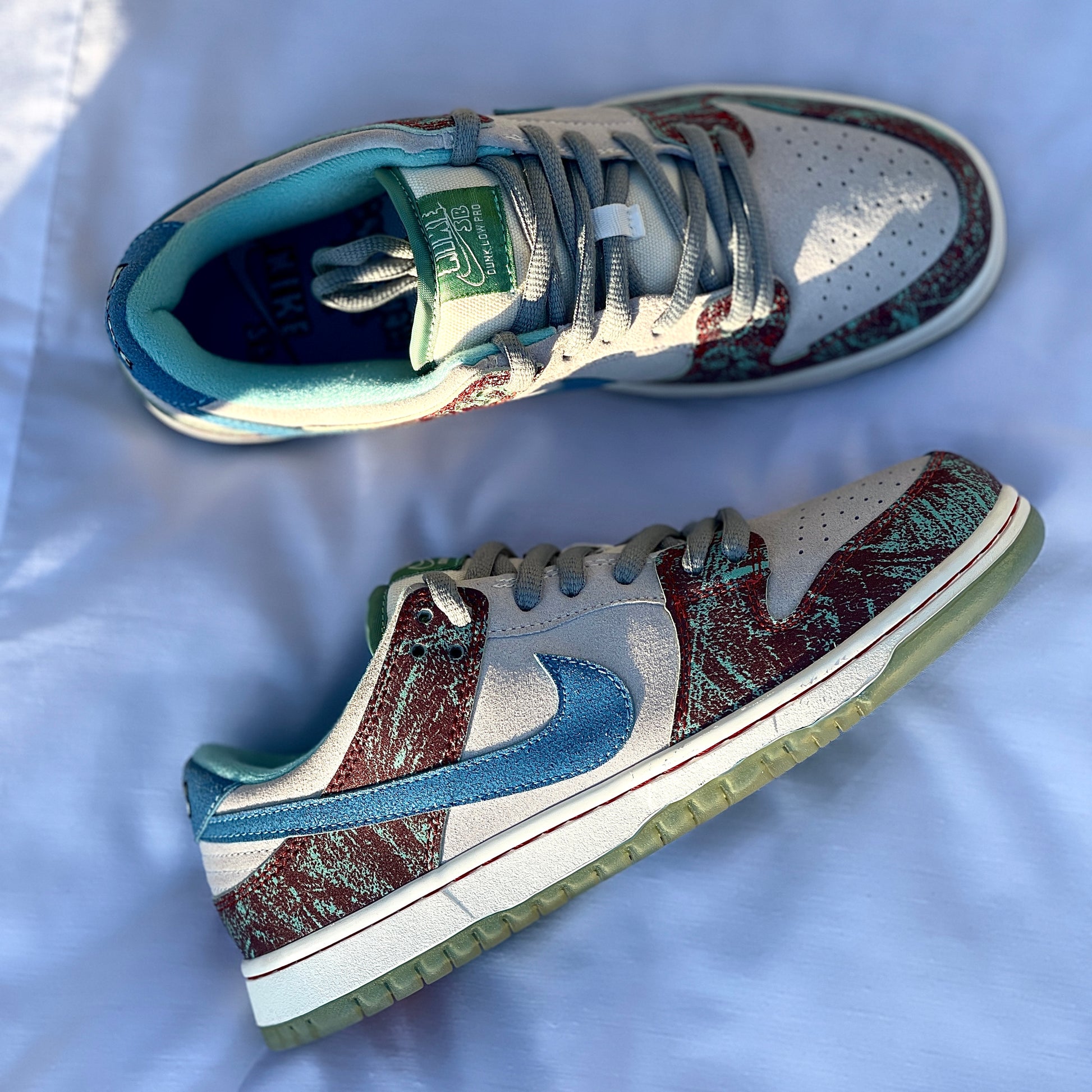 Close-up of green suede overlays on CSC Dunk Low SB