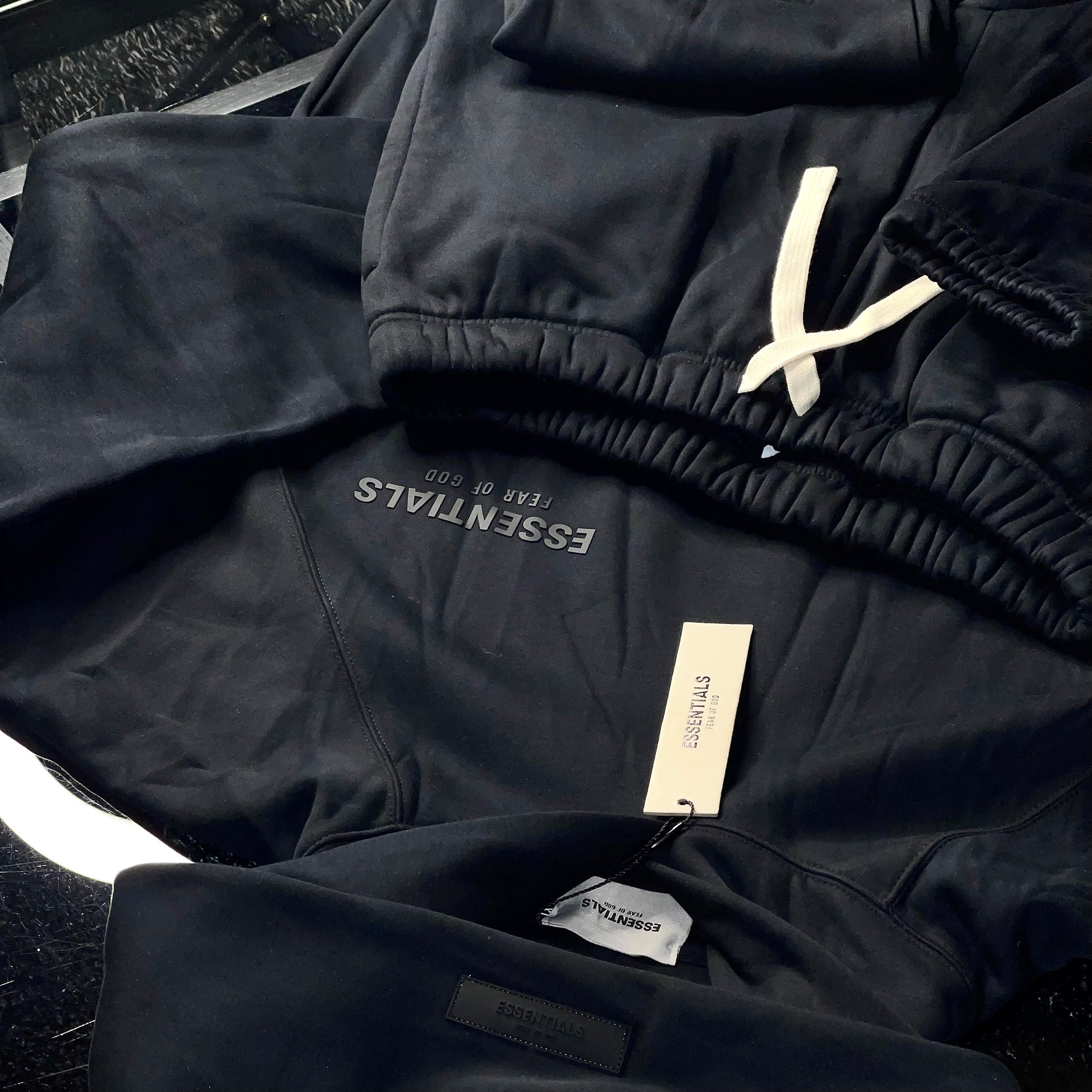 Close-up of Essentials Fear of God Core Collection Black sweatshirt with tonal logo detailing