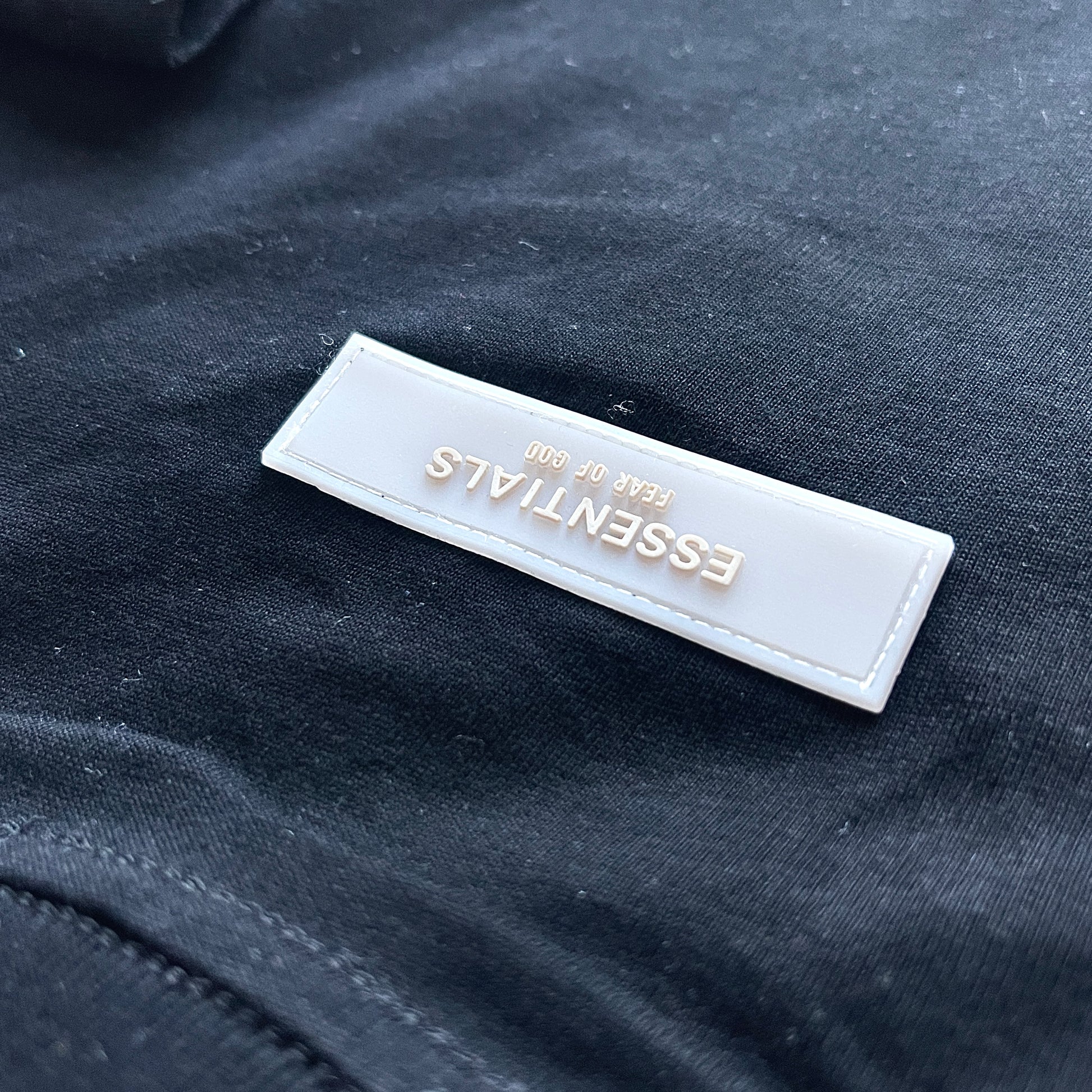 Close-up of Essentials logo detail on T-Shirt