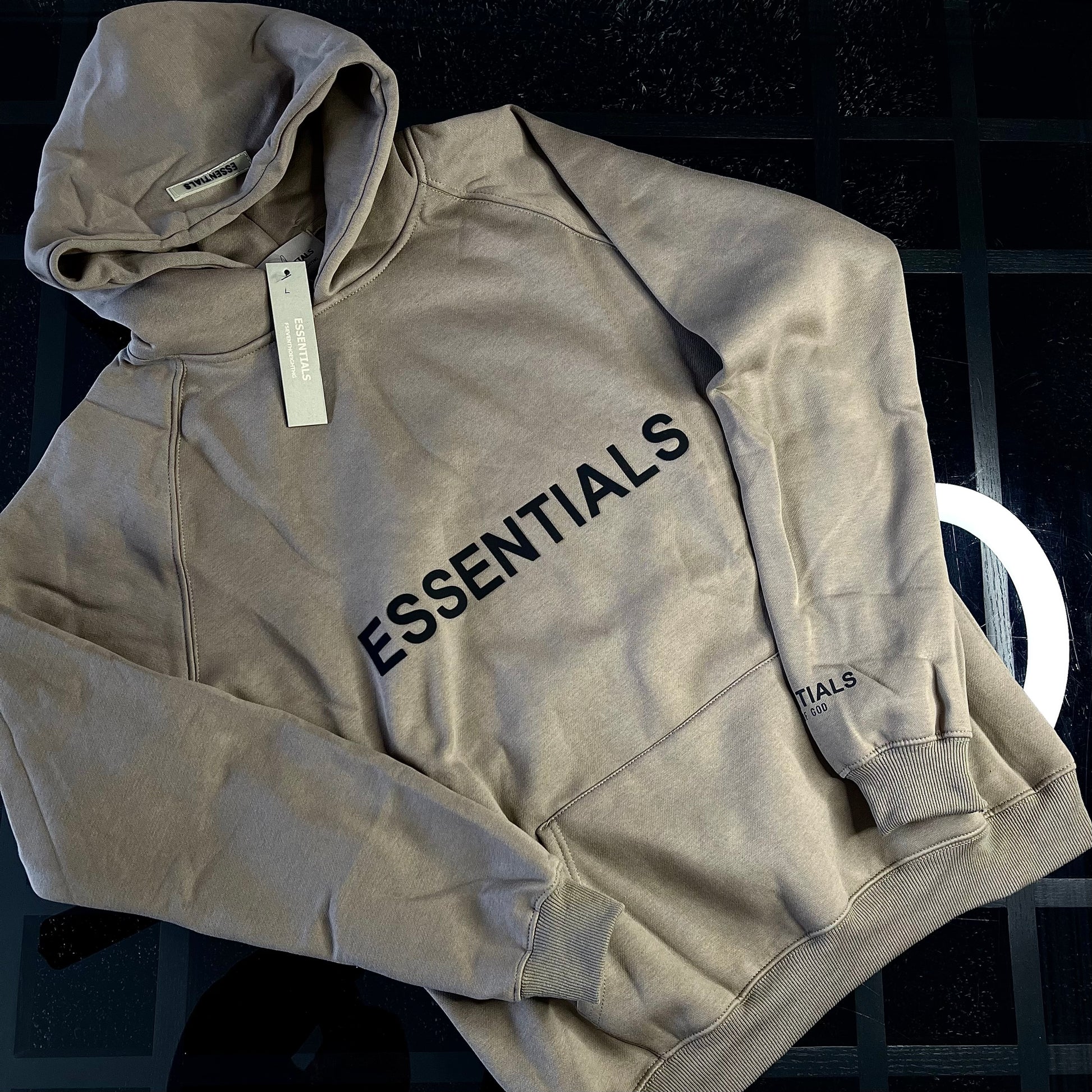 Fear of God Essentials Hoodie Light Oatmeal front view — relaxed fit beige hoodie with minimalist logo branding