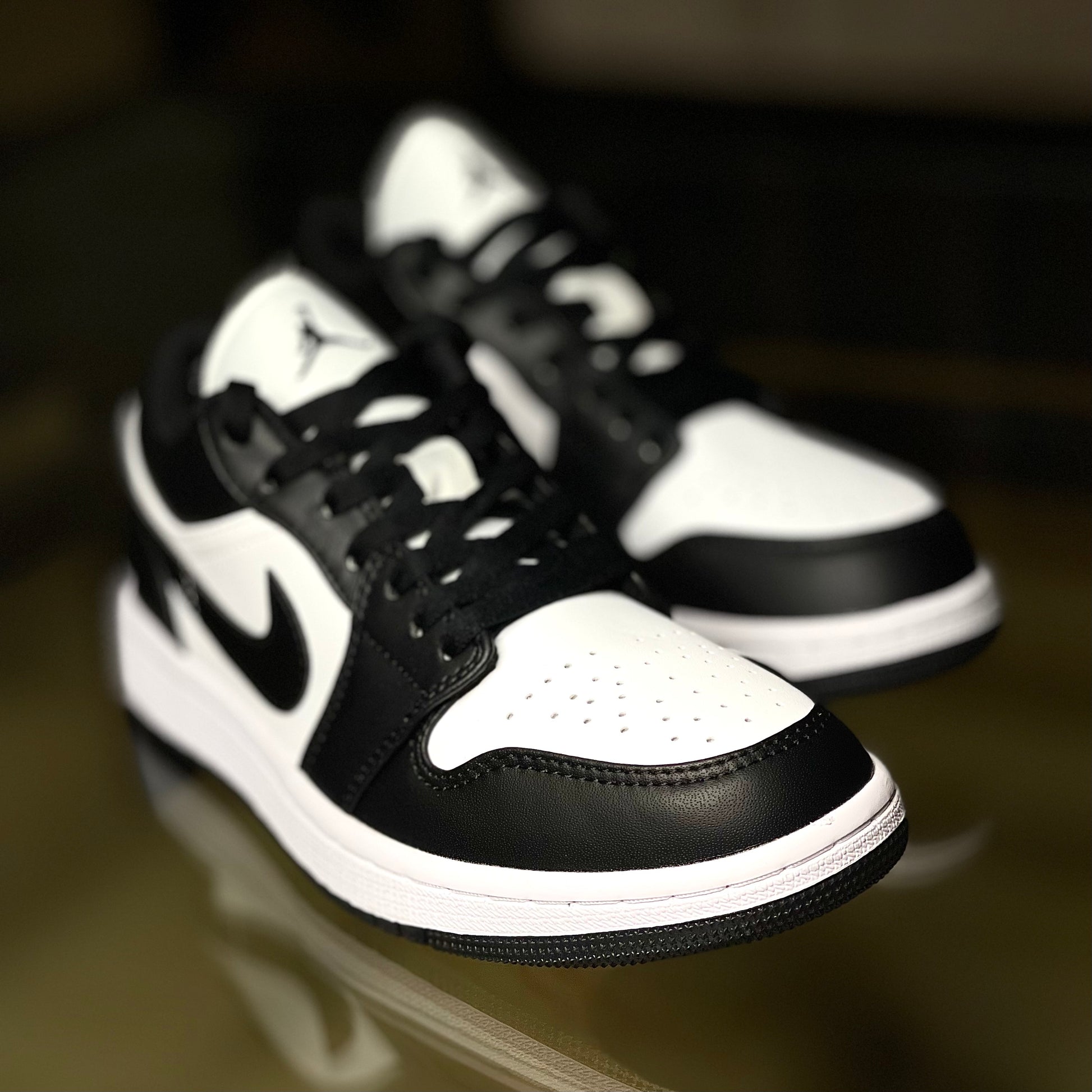 Close-up of Air Jordan 1 Low Panda leather upper with black overlays and white base