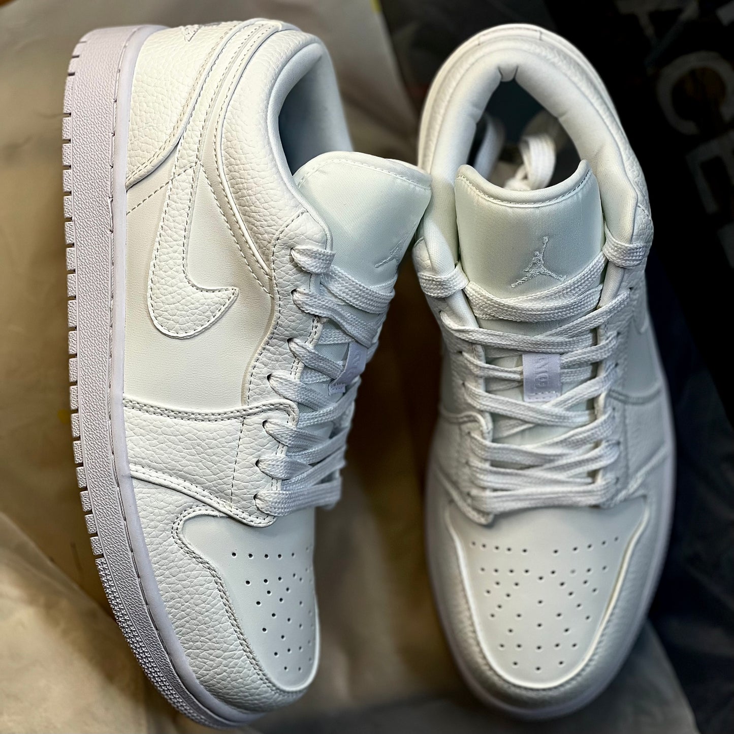Top view of Air Jordan 1 Low Triple White showing perforated toe box and lace structure