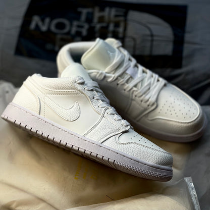 Air Jordan 1 Low Triple White featuring tonal Nike Swoosh and Air Jordan Wings logo on heel