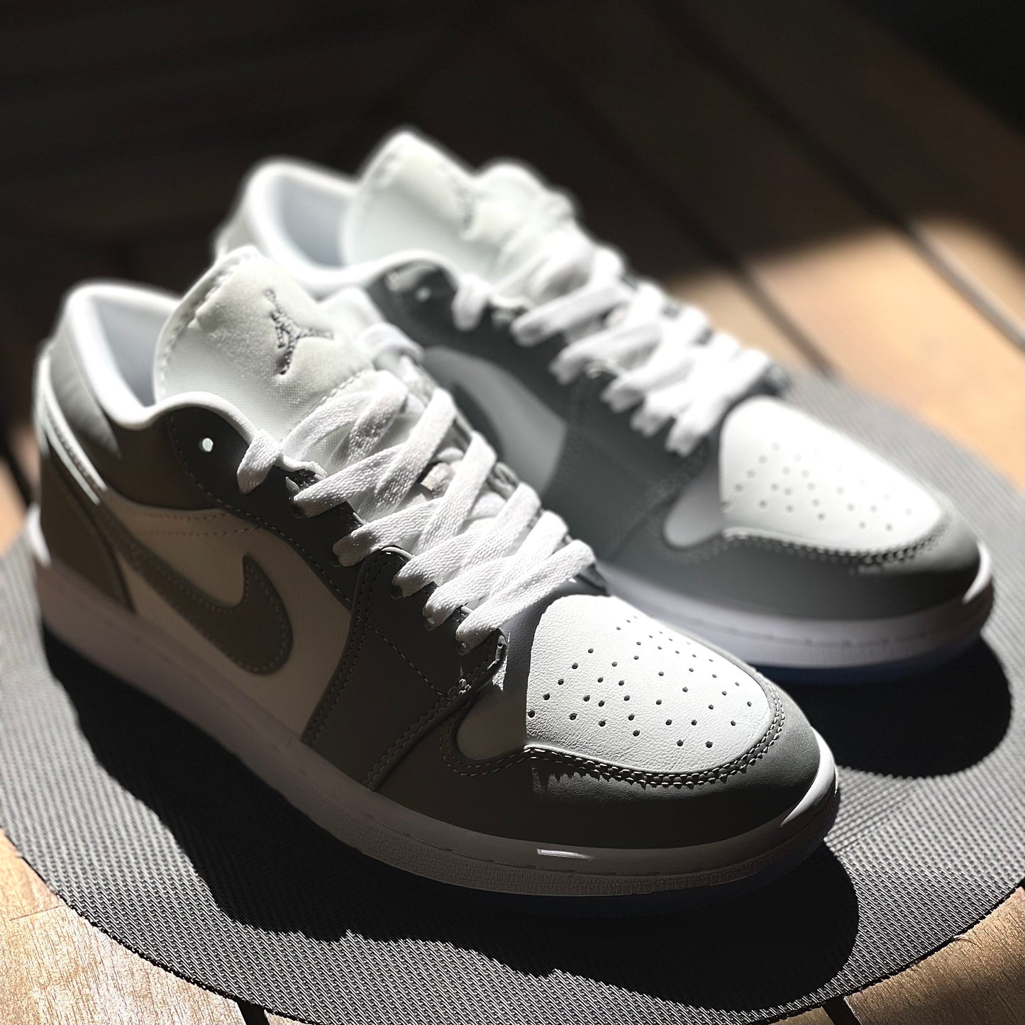 Close-up of Air Jordan 1 Low Wolf Grey leather upper with white base and grey overlays