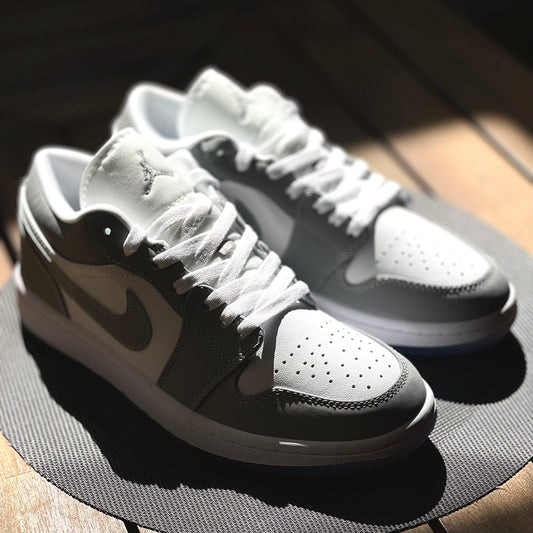 Close-up of Air Jordan 1 Low Wolf Grey leather upper with white base and grey overlays