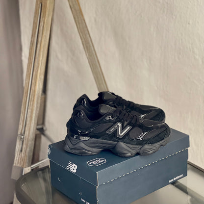 New Balance 9060 Black Cat side view — all-black retro-inspired sneaker with layered leather and mesh upper