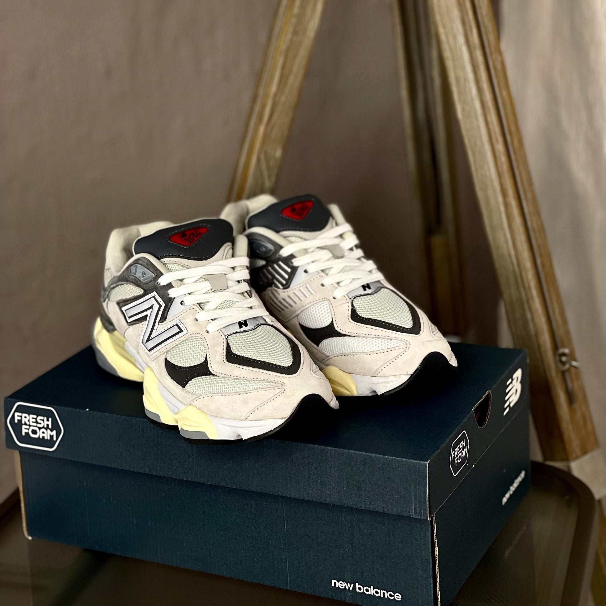 Angled view of New Balance 9060 Raincloud with Casterlock and White — grey and white sneaker highlighting modern-retro design and comfort features