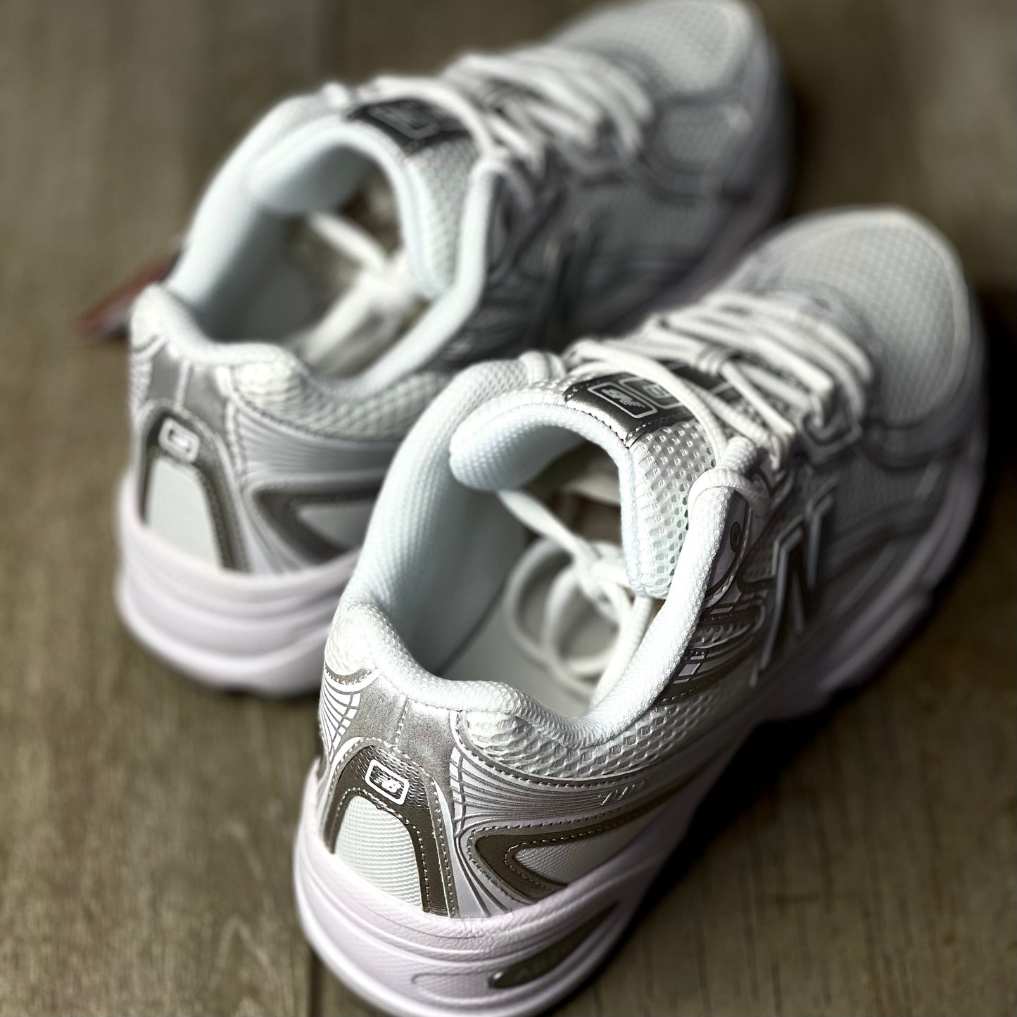 Rear view of New Balance 740 V2 white silver reflection showing heel counter and reflective branding.