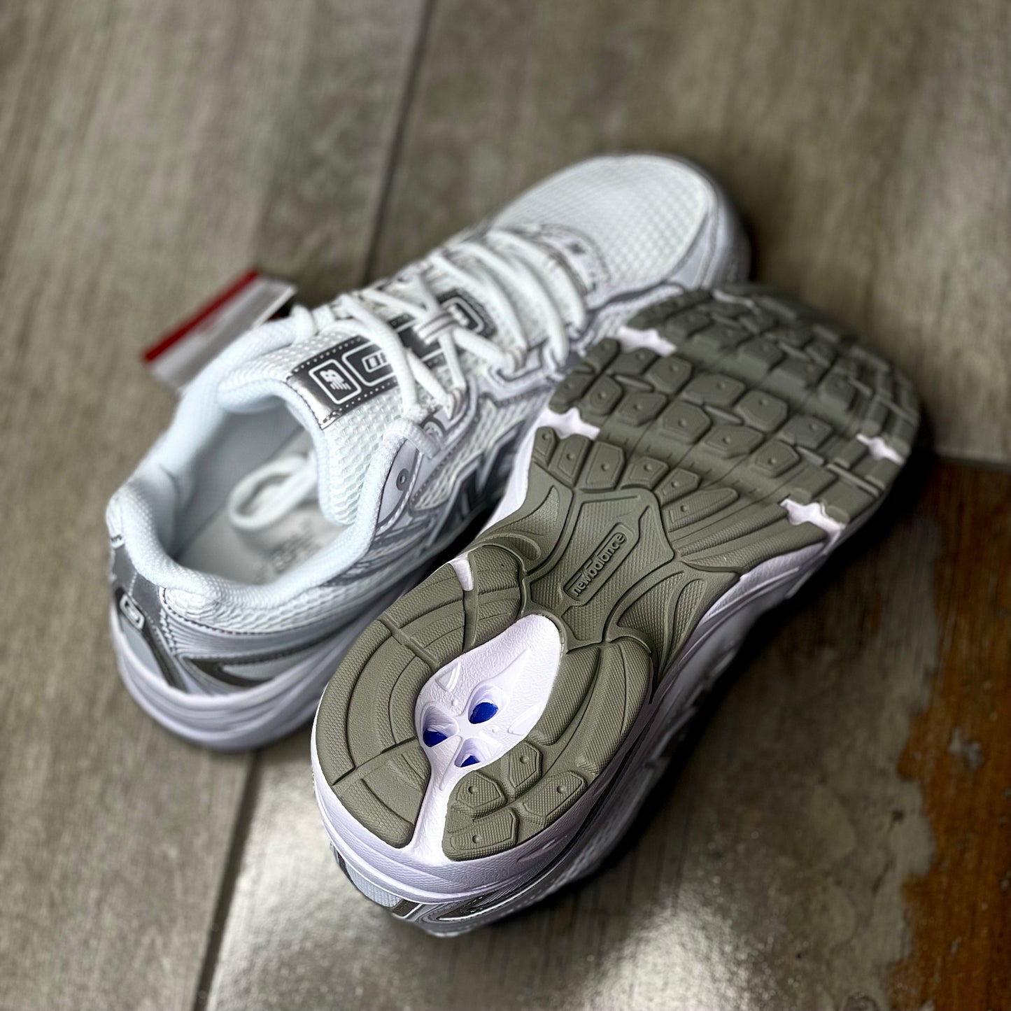 Outsole of New Balance 740 V2 white silver reflection sneaker with tread pattern for grip and durability