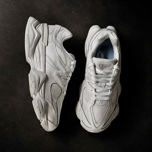 Pair of New Balance 9060 Triple White sneakers angled together