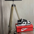 Nike Dunk Low Panda side view — black and white low-top sneaker with leather upper and classic Dunk silhouette