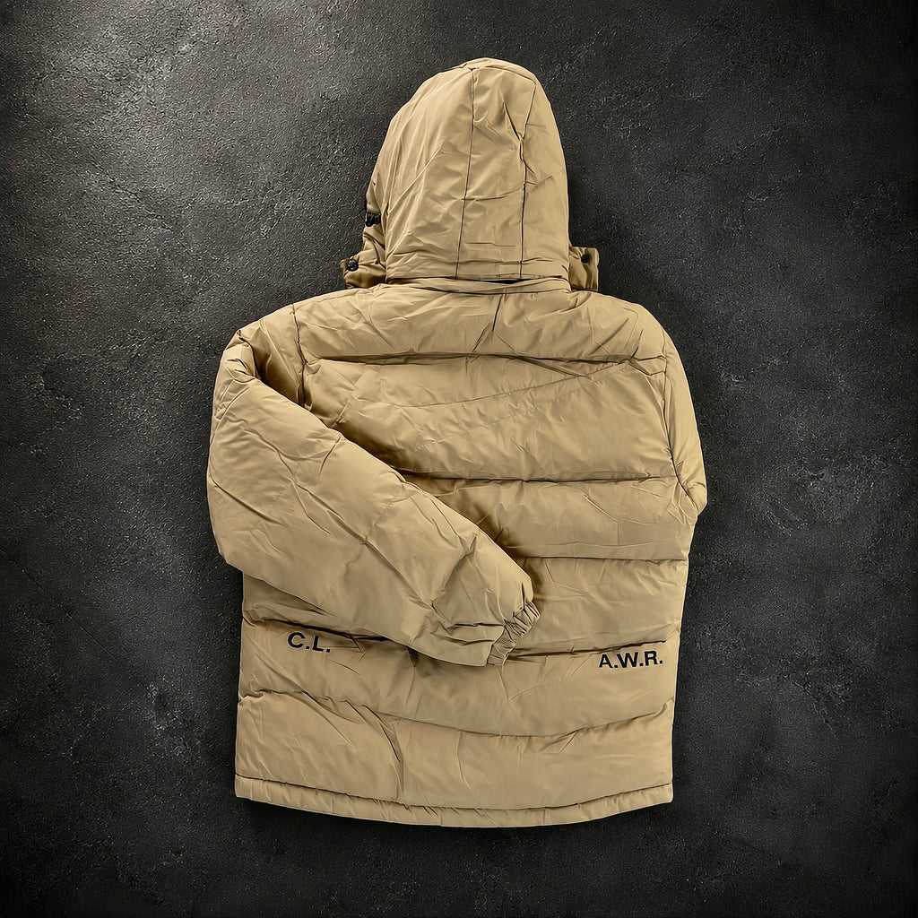 Nike x Drake NOCTA Storm-FIT Skulpeak Puffer Jacket Bone rear angled view highlighting quilted insulation, technical outer shell and premium NOCTA craftsmanship.