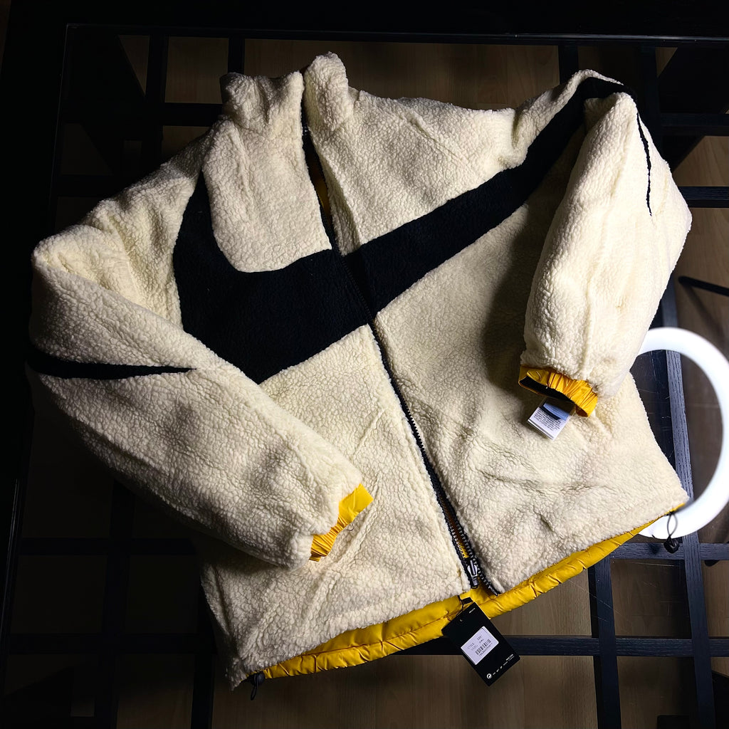 Nike NOCTA Reversible Puffer Jacket University Gold featuring reversible black interior and logo accents